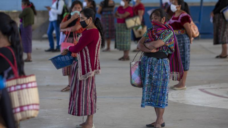Women wearing face masks stand at a safe distance to help curb the spread of the new coronavirus, as they wait for food assigned to their children outside a school in Xesuj, Guatemala, where many residents depend on remittances, largely from the U.S. The Women wearing face masks stand at a safe distance to help curb the spread of the new coronavirus, as they wait for food assigned to their children outside a school in Xesuj, Guatemala, where many residents depend on remittances, largely from the U.S. The
