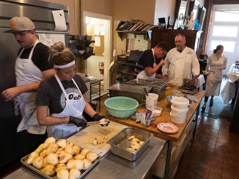 Chef Patrick Mulvaney talks with his kitchen staff as they prepare dinner at B&L restaurant. Chef Patrick Mulvaney talks with his kitchen staff as they prepare dinner at B&L restaurant.
