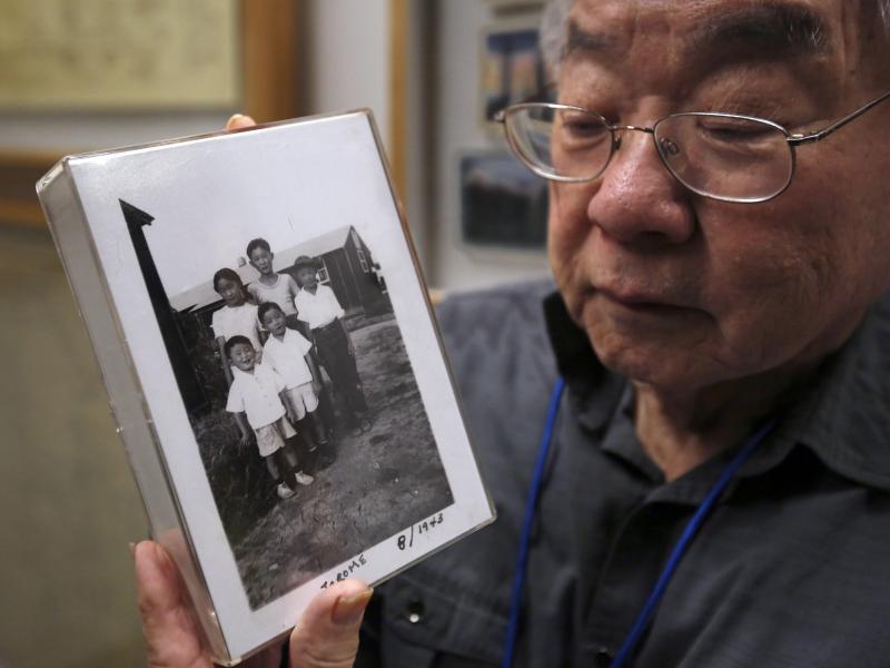 During a visit last week to the California Museum in Sacramento, Les Ouchida holds a 1943 photo of himself (front row center) and his siblings taken at the internment camp in Jerome, Ark., that his family was moved to from their home near Sacramento in 19 During a visit last week to the California Museum in Sacramento, Les Ouchida holds a 1943 photo of himself (front row center) and his siblings taken at the internment camp in Jerome, Ark., that his family was moved to from their home near Sacramento in 19
