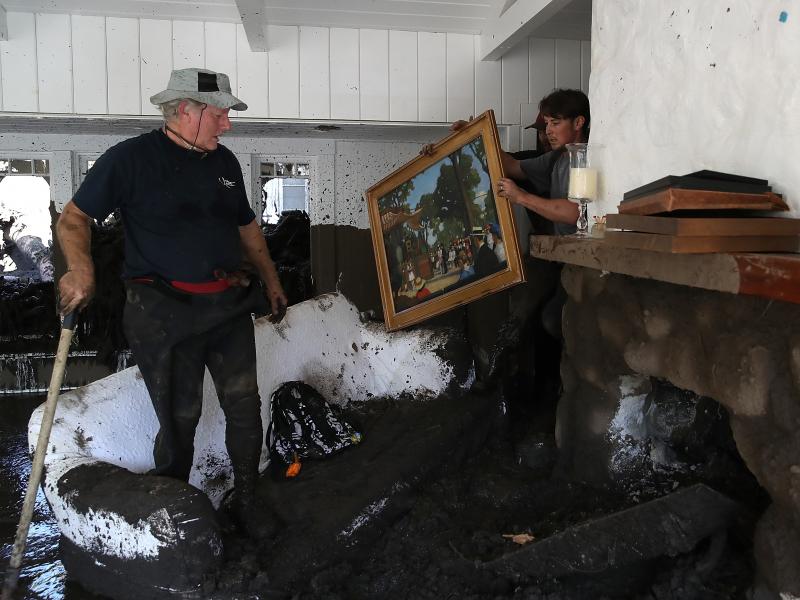 David Drenic (L) and Robert Drenic (R) look for salvageable items in a the home of a family member that was destroyed by a mudslide on Jan. 11, in Montecito, Calif. David Drenic (L) and Robert Drenic (R) look for salvageable items in a the home of a family member that was destroyed by a mudslide on Jan. 11, in Montecito, Calif.