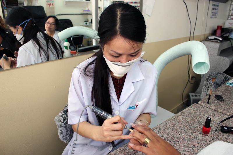 Mai Dang, who owns Fashion Nails in Berkeley, Calif., does a client's nails. The ventilator hose poised over her shoulder helps keeps noxious fumes at bay. Mai Dang, who owns Fashion Nails in Berkeley, Calif., does a client's nails. The ventilator hose poised over her shoulder helps keeps noxious fumes at bay.
