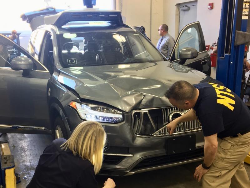 Investigators for the National Transportation Safety Board in Tempe, Ariz., examine the Uber vehicle involved in the fatal crash. Investigators for the National Transportation Safety Board in Tempe, Ariz., examine the Uber vehicle involved in the fatal crash.