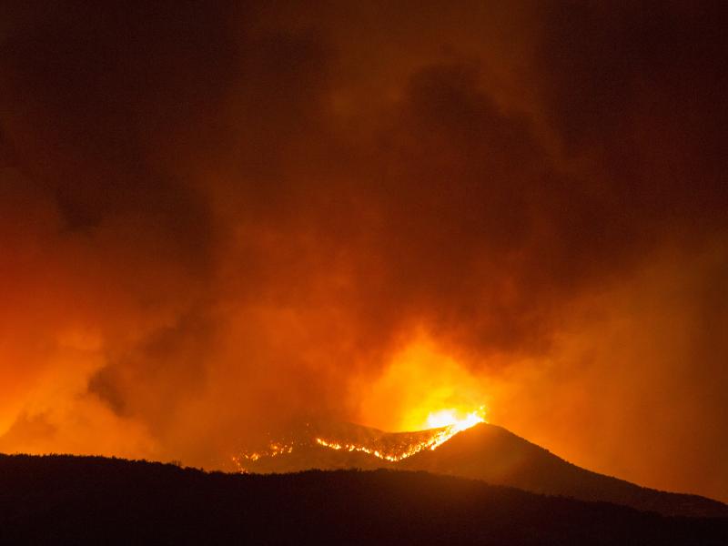 A brush fire burns amid the Apple Fire in Banning, Calif. on Saturday. A brush fire burns amid the Apple Fire in Banning, Calif. on Saturday.