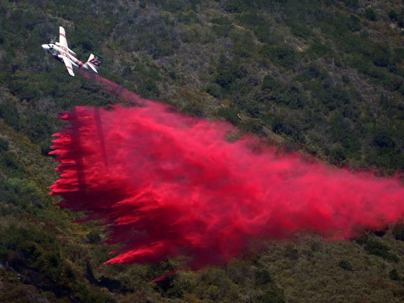 A plane drops fire retardant onto the fire on Thursday in Laguna Niguel, Calif. A plane drops fire retardant onto the fire on Thursday in Laguna Niguel, Calif.