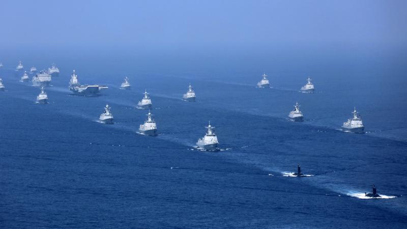 An April 2018 file photo released by China's Xinhua News Agency shows the Liaoning aircraft carrier accompanied by navy frigates and submarines conducting exercises in the South China Sea. An April 2018 file photo released by China's Xinhua News Agency shows the Liaoning aircraft carrier accompanied by navy frigates and submarines conducting exercises in the South China Sea.