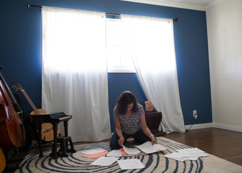 Jeannine sorts through a binder of writing assignments from her therapy. In keeping a journal about her past experiences with pain, she noticed that the pain symptoms began when she was around 8 — a time of escalating family trauma at home. Jeannine sorts through a binder of writing assignments from her therapy. In keeping a journal about her past experiences with pain, she noticed that the pain symptoms began when she was around 8 — a time of escalating family trauma at home.