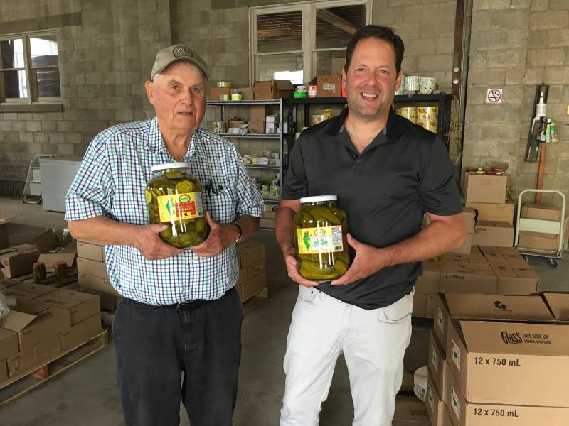 Don Woodbridge (left) and son Alan Woodbridge hold jars of pickles at their company in Harrow, Ontario. Orders are up in anticipation of retaliatory Canadian tariffs on U.S. gherkins. Don Woodbridge (left) and son Alan Woodbridge hold jars of pickles at their company in Harrow, Ontario. Orders are up in anticipation of retaliatory Canadian tariffs on U.S. gherkins.