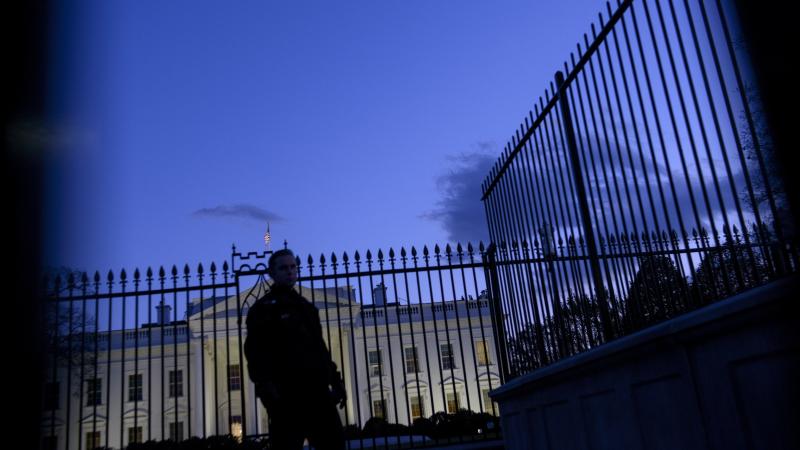 A member of the Secret Service's uniformed division stands by a fence in front of the White House. A member of the Secret Service's uniformed division stands by a fence in front of the White House.