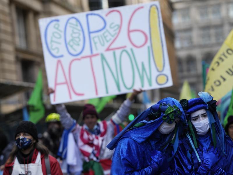 Activists protesting "greenwashing," in which a company or government appears to do more for the environment than it is, gather outside the JP Morgan premises near the COP26 U.N. Climate Summit. Activists protesting "greenwashing," in which a company or government appears to do more for the environment than it is, gather outside the JP Morgan premises near the COP26 U.N. Climate Summit.