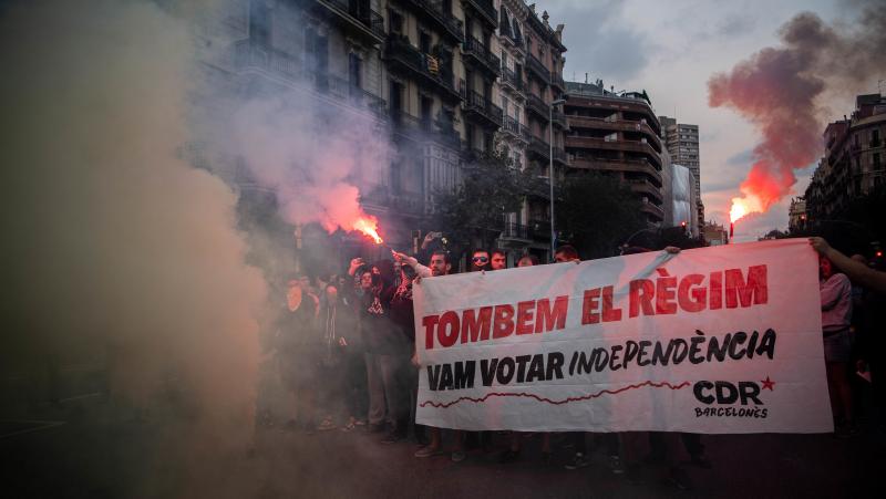 Independence supporters block a street during a demonstration to commemorate the anniversary of the referendum last year. Their sign, written in Catalan, reads: "Let's change the regime. We voted for independence." Independence supporters block a street during a demonstration to commemorate the anniversary of the referendum last year. Their sign, written in Catalan, reads: "Let's change the regime. We voted for independence."