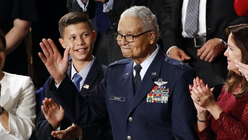 Tuskegee Airman Charles McGee and his great grandson Iain Lanphier are seen during President Donald Trump's State of the Union address on Feb. 4, 2020. McGee, one of the last surviving Tuskegee Airmen, who flew 409 fighter combat missions over three wars, Tuskegee Airman Charles McGee and his great grandson Iain Lanphier are seen during President Donald Trump's State of the Union address on Feb. 4, 2020. McGee, one of the last surviving Tuskegee Airmen, who flew 409 fighter combat missions over three wars,