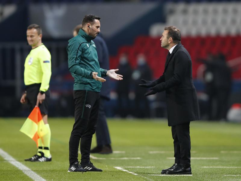 Basaksehir team manager Okan Buruk (right) argues with referee Sebastian Coltescu during a Champions League soccer match between Paris Saint Germain and Istanbul Basaksehir in Paris on Tuesday. Basaksehir team manager Okan Buruk (right) argues with referee Sebastian Coltescu during a Champions League soccer match between Paris Saint Germain and Istanbul Basaksehir in Paris on Tuesday.