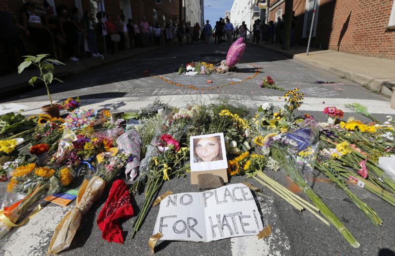 A makeshift memorial of flowers and a photo of victim Heather Heyer sits in Charlottesville, Va., on Aug. 13, 2017. Heyer died when a car rammed into a group of people who were protesting white supremacists who had gathered in the city for a rally. A makeshift memorial of flowers and a photo of victim Heather Heyer sits in Charlottesville, Va., on Aug. 13, 2017. Heyer died when a car rammed into a group of people who were protesting white supremacists who had gathered in the city for a rally.