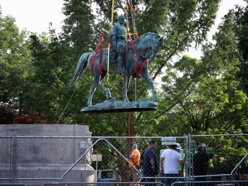 Workers remove a statue of Confederate Gen. Robert E. Lee in Charlottesville, Va., in July. Initial plans to remove the statue four years ago sparked the infamous Unite the Right rally where 32-year-old Heather Heyer was killed. Workers remove a statue of Confederate Gen. Robert E. Lee in Charlottesville, Va., in July. Initial plans to remove the statue four years ago sparked the infamous Unite the Right rally where 32-year-old Heather Heyer was killed.