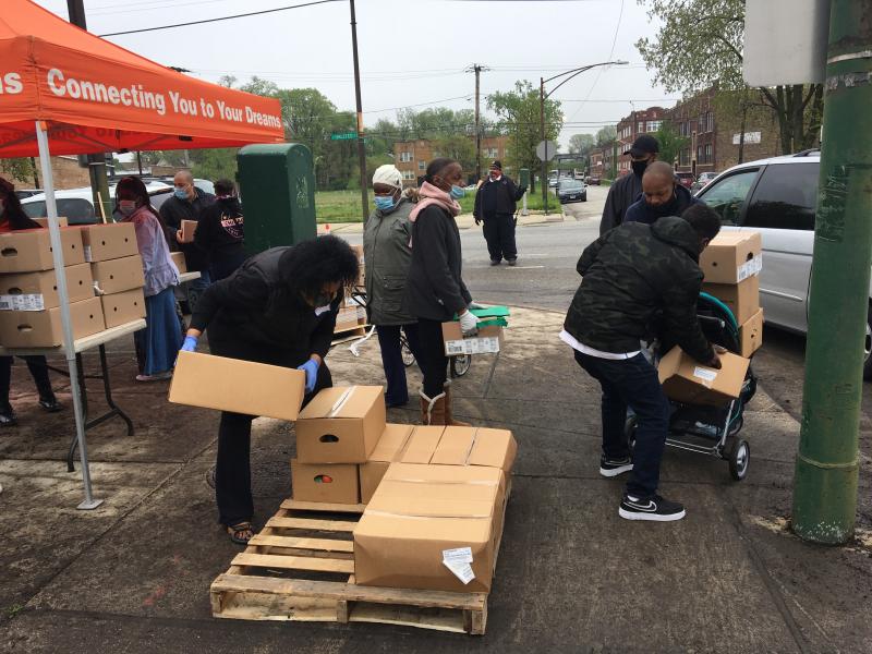 Residents of the Auburn Gresham neighborhood in Chicago line up for boxes of food at a weekly pop-up food pantry. Residents of the Auburn Gresham neighborhood in Chicago line up for boxes of food at a weekly pop-up food pantry.