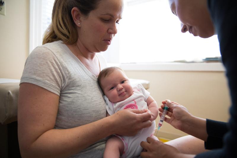 Julie Brand holds her 1-month-old daughter as she receives a hepatitis B vaccine at Berkeley Pediatrics in Berkeley, Calif. Julie Brand holds her 1-month-old daughter as she receives a hepatitis B vaccine at Berkeley Pediatrics in Berkeley, Calif.