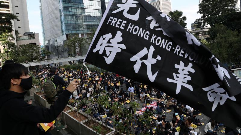 "China urges the U.S. to correct its mistake and stop meddling in Hong Kong affairs," a government spokesperson says, as China retaliates for U.S. support of pro-democracy demonstrators. Here, an activist holds a flag at a lunchtime protest Monday at Chat "China urges the U.S. to correct its mistake and stop meddling in Hong Kong affairs," a government spokesperson says, as China retaliates for U.S. support of pro-democracy demonstrators. Here, an activist holds a flag at a lunchtime protest Monday at Chat