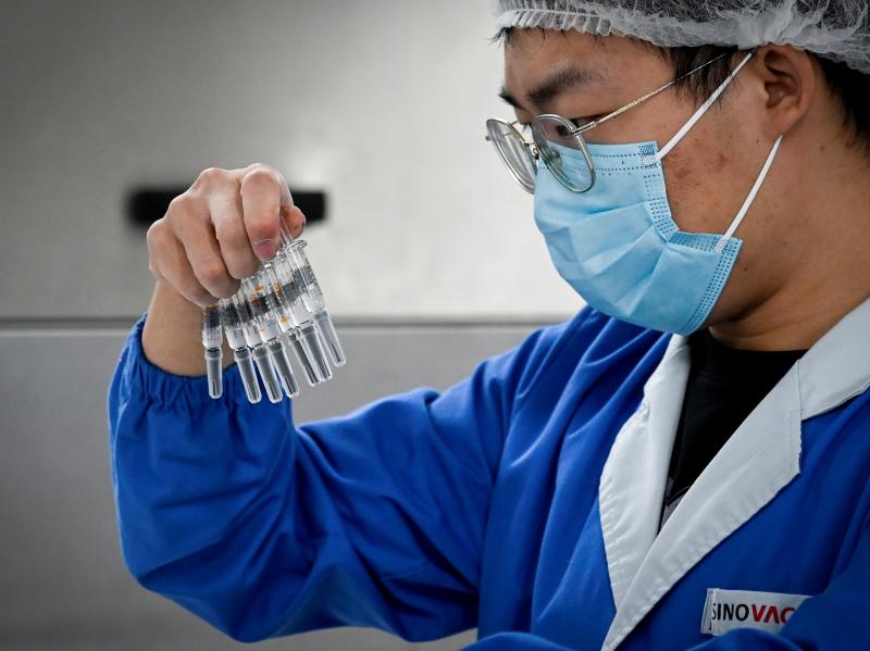 A staff member checks vaccines at a Beijing factory built by Sinovac to produce a COVID-19 coronavirus vaccine. Sinovac is one of 11 Chinese companies approved to carry out clinical trials of potential vaccines. A staff member checks vaccines at a Beijing factory built by Sinovac to produce a COVID-19 coronavirus vaccine. Sinovac is one of 11 Chinese companies approved to carry out clinical trials of potential vaccines.