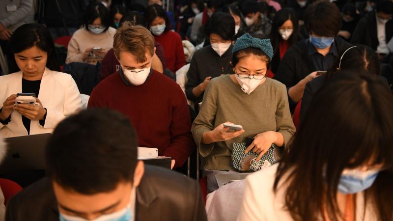 Journalists wearing face masks — in an effort to protect against the coronavirus — gather for a news conference earlier this year in Beijing. Early Wednesday, China said it was planning to pull the press credentials of certain journalists employed by Journalists wearing face masks — in an effort to protect against the coronavirus — gather for a news conference earlier this year in Beijing. Early Wednesday, China said it was planning to pull the press credentials of certain journalists employed by