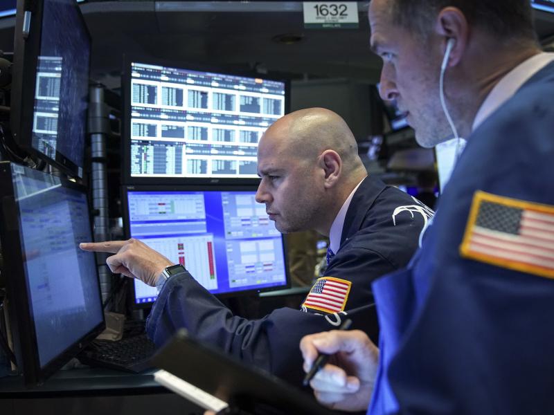 Traders and financial professionals work on the floor of the New York Stock Exchange on Monday. U.S. stock markets fell sharply at the open but crept higher as the day wore on after President Trump threatened to raise tariffs on imports from China. Traders and financial professionals work on the floor of the New York Stock Exchange on Monday. U.S. stock markets fell sharply at the open but crept higher as the day wore on after President Trump threatened to raise tariffs on imports from China.