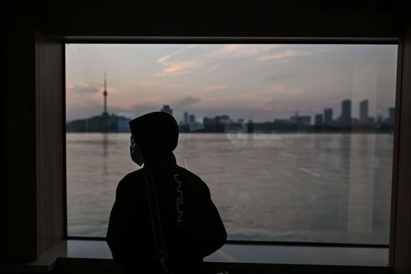 A man wearing a face mask travels on a ferry to cross the Yangtze River in Wuhan in April. Chinese officials are working to silence people suspected of challenging the narrative that authorities in Wuhan and Beijing acted swiftly and efficiently to contai A man wearing a face mask travels on a ferry to cross the Yangtze River in Wuhan in April. Chinese officials are working to silence people suspected of challenging the narrative that authorities in Wuhan and Beijing acted swiftly and efficiently to contai
