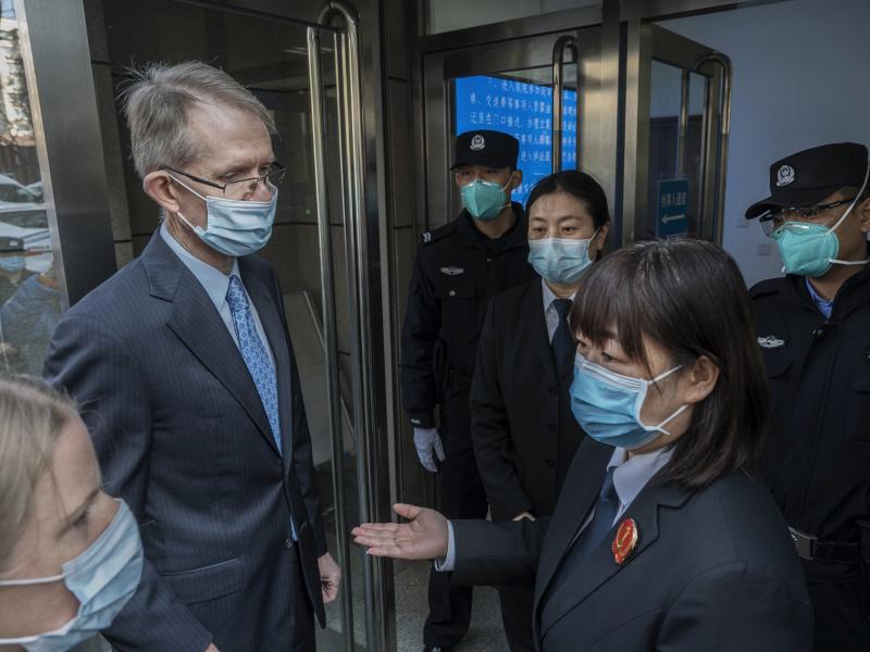 Australian Ambassador to China Graham Fletcher, left, is turned away by court officials and police as he tried to enter the trial of Chinese Australian journalist Cheng Lei at the Beijing Number 2 Intermediate People's Court on Thursday in Beijing. Australian Ambassador to China Graham Fletcher, left, is turned away by court officials and police as he tried to enter the trial of Chinese Australian journalist Cheng Lei at the Beijing Number 2 Intermediate People's Court on Thursday in Beijing.