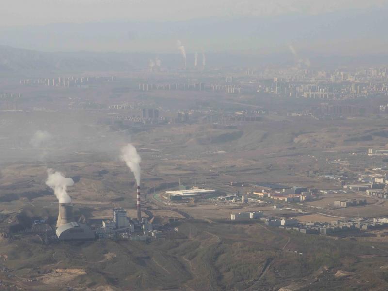 Smoke and steam rise from towers at the coal-fired Urumqi Thermal Power Plant as seen from a plane in Urumqi in western China's Xinjiang Uyghur Autonomous Region on April 21, 2021. Smoke and steam rise from towers at the coal-fired Urumqi Thermal Power Plant as seen from a plane in Urumqi in western China's Xinjiang Uyghur Autonomous Region on April 21, 2021.
