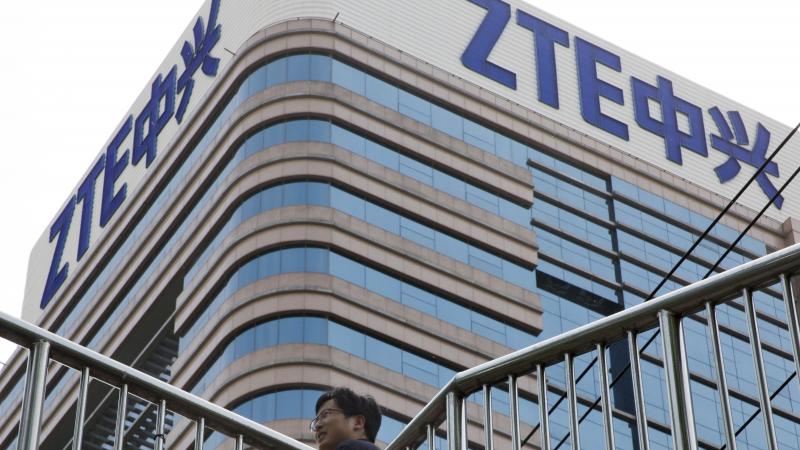 A man walks past a building with the ZTE logos in Beijing in a photo taken last month. A man walks past a building with the ZTE logos in Beijing in a photo taken last month.