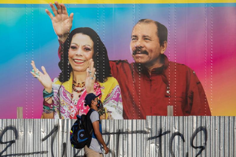 A man walks by a mobile health clinic displaying a picture of Nicaraguan President Daniel Ortega (right) and his wife and vice president, Rosario Murillo, in Managua on April 14, 2020. The government claims to be successfully combating the pandemic but he A man walks by a mobile health clinic displaying a picture of Nicaraguan President Daniel Ortega (right) and his wife and vice president, Rosario Murillo, in Managua on April 14, 2020. The government claims to be successfully combating the pandemic but he