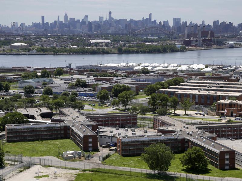 The Rikers Island jail complex in New York with the Manhattan skyline in the background. New York City lawmakers voted on Thursday to close the notorious jail complex. The Rikers Island jail complex in New York with the Manhattan skyline in the background. New York City lawmakers voted on Thursday to close the notorious jail complex.