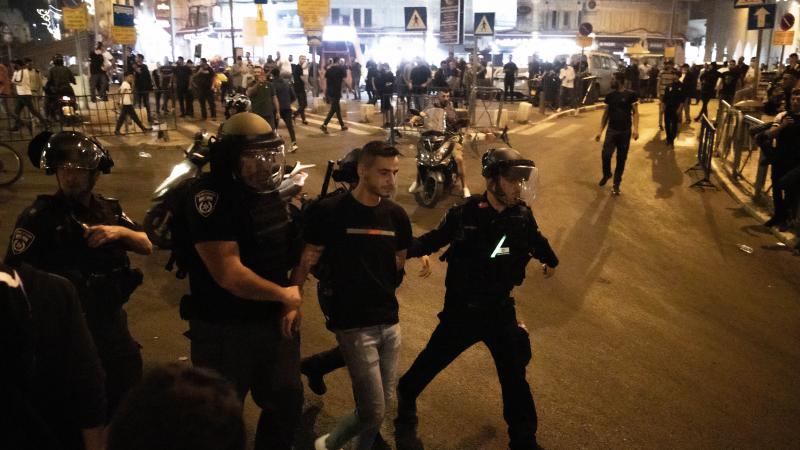 Israeli police take a Palestinian into custody during a protest at the Masjid al-Aqsa compound in East Jerusalem on Sunday. Israeli police take a Palestinian into custody during a protest at the Masjid al-Aqsa compound in East Jerusalem on Sunday.