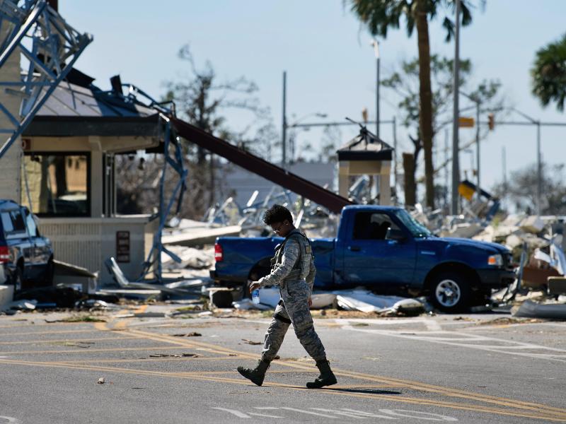 A military police officer walks near a destroyed gate in Tyndall Air Force Base in Florida in the aftermath of Hurricane Michael on Oct. 12, 2018. The Pentagon says climate change is a national security concern. A military police officer walks near a destroyed gate in Tyndall Air Force Base in Florida in the aftermath of Hurricane Michael on Oct. 12, 2018. The Pentagon says climate change is a national security concern.