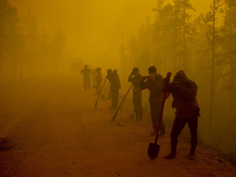 Volunteer firefighters rest west of Yakutsk, Russia, in August 2021. Wildfires are getting more common in Siberia, undercutting the ability of the region's vast forests to absorb carbon dioxide from the atmosphere. Volunteer firefighters rest west of Yakutsk, Russia, in August 2021. Wildfires are getting more common in Siberia, undercutting the ability of the region's vast forests to absorb carbon dioxide from the atmosphere.