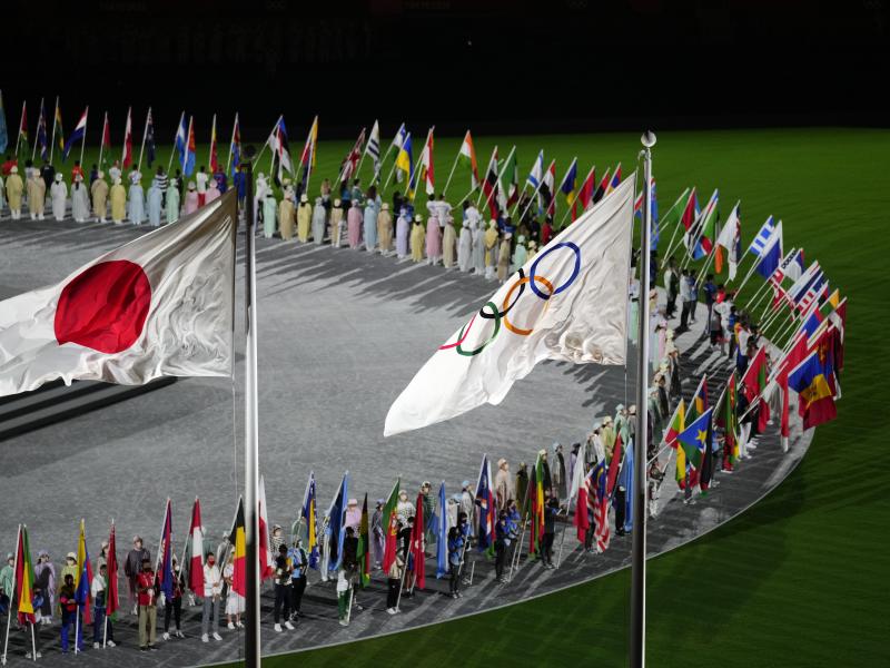 The Japan and Olympic flags fly as country flags are carried in during the closing ceremony in the Olympic Stadium at the Summer Olympics on Sunday in Tokyo. The Japan and Olympic flags fly as country flags are carried in during the closing ceremony in the Olympic Stadium at the Summer Olympics on Sunday in Tokyo.