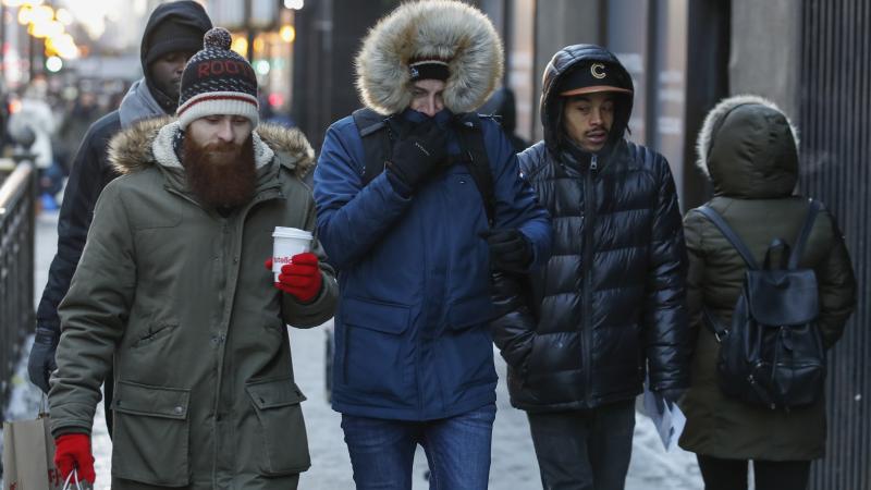 Pedestrians walk along Michigan Avenue in Chicago this week. Bitter cold is hitting much of the Northern half of the U.S., with temperatures dipping into the single digits and below zero. The extremely frigid weather is expected to last for days. Pedestrians walk along Michigan Avenue in Chicago this week. Bitter cold is hitting much of the Northern half of the U.S., with temperatures dipping into the single digits and below zero. The extremely frigid weather is expected to last for days.