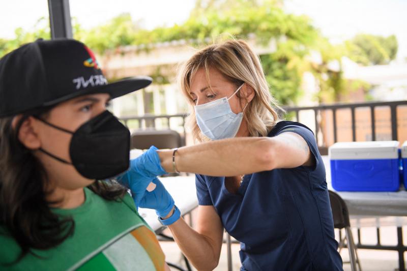 A nurse administers a dose of the Pfizer COVID-19 vaccine during a City of Long Beach Public Health mobile vaccination clinic at the California State University, Long Beach campus. A nurse administers a dose of the Pfizer COVID-19 vaccine during a City of Long Beach Public Health mobile vaccination clinic at the California State University, Long Beach campus.