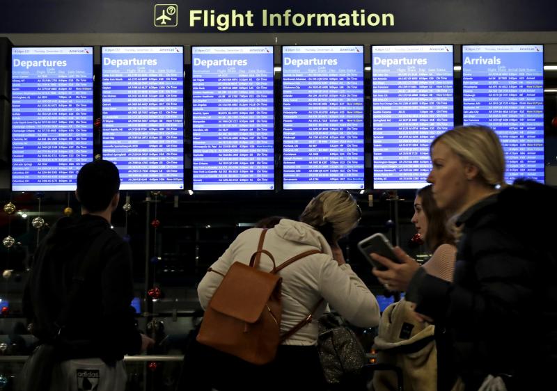 Travelers walk and check their flight information in Terminal 3 at Chicago's O'Hare International Airport in December. Travelers walk and check their flight information in Terminal 3 at Chicago's O'Hare International Airport in December.