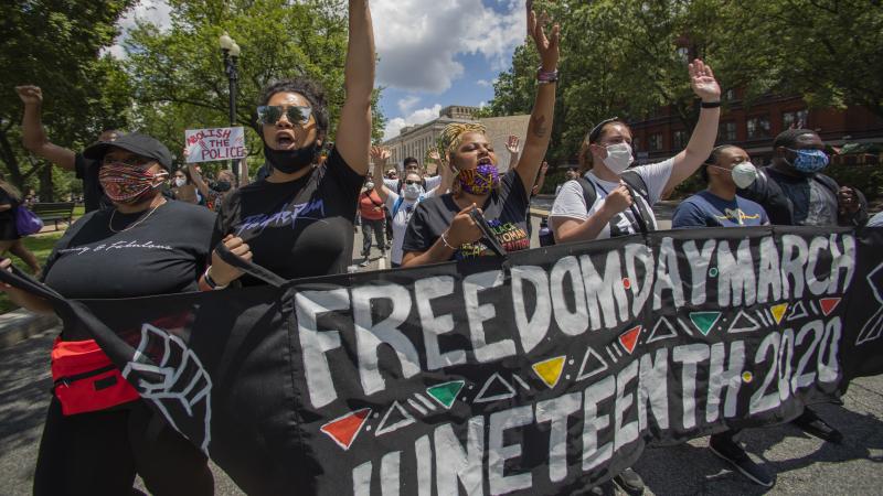People observe a moment of silence at the Martin Luther King Jr. Memorial in Washington on June 19, 2020, to mark Juneteenth. People observe a moment of silence at the Martin Luther King Jr. Memorial in Washington on June 19, 2020, to mark Juneteenth.