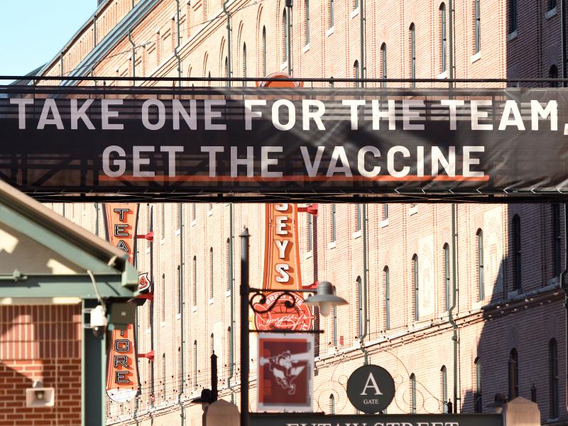 A sign outside Camden Yards in Baltimore, Maryland, encourages people to get a COVID-19 vaccine. A sign outside Camden Yards in Baltimore, Maryland, encourages people to get a COVID-19 vaccine.