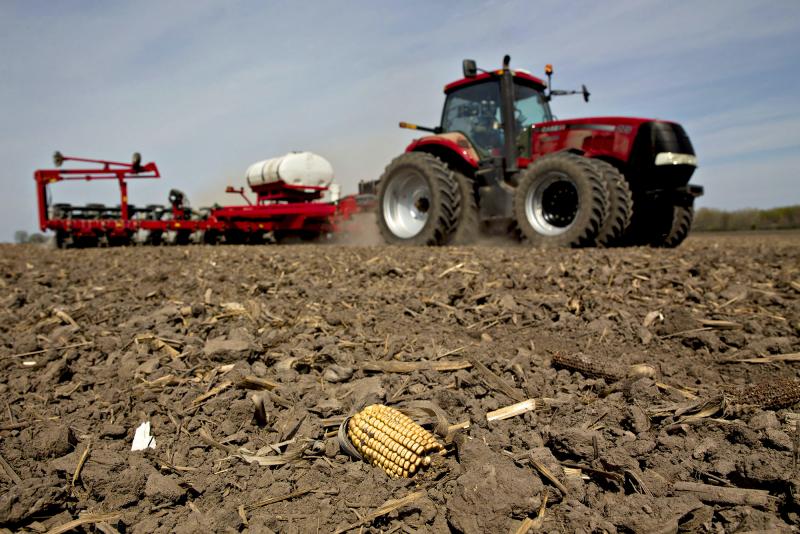 A tractor pulls a planter through a field as corn is planted in Princeton, Ill. A tractor pulls a planter through a field as corn is planted in Princeton, Ill.