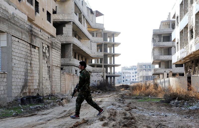 A Syrian soldier walks on a ravaged street in Daraya, a besieged suburb of Syria's capital, in February. A Syrian soldier walks on a ravaged street in Daraya, a besieged suburb of Syria's capital, in February.