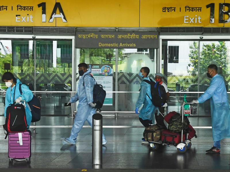 Air passengers wearing practically full-body coveralls at the Netaji Subhas Chandra Bose International Airport in India. Air passengers wearing practically full-body coveralls at the Netaji Subhas Chandra Bose International Airport in India.