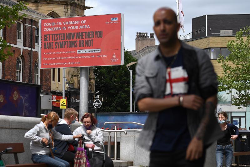 A sign urges people to get tested for a COVID-19 variant in Blackburn, England. The U.K. is experiencing a surge in the delta variant, which was first identified in India. A sign urges people to get tested for a COVID-19 variant in Blackburn, England. The U.K. is experiencing a surge in the delta variant, which was first identified in India.