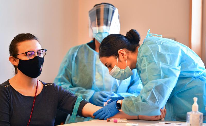 A phlebotomist draws blood at a free COVID-19 antibody testing event on Feb.17 in Pico Rivera, Calif. A phlebotomist draws blood at a free COVID-19 antibody testing event on Feb.17 in Pico Rivera, Calif.