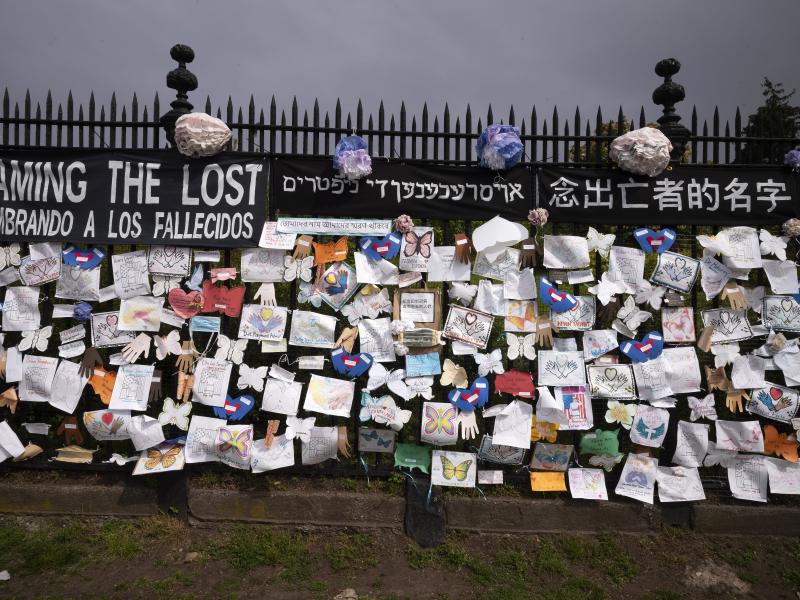A fence outside Brooklyn's Green-Wood Cemetery is adorned with tributes to victims of COVID-19 on Thursday in New York. A fence outside Brooklyn's Green-Wood Cemetery is adorned with tributes to victims of COVID-19 on Thursday in New York.