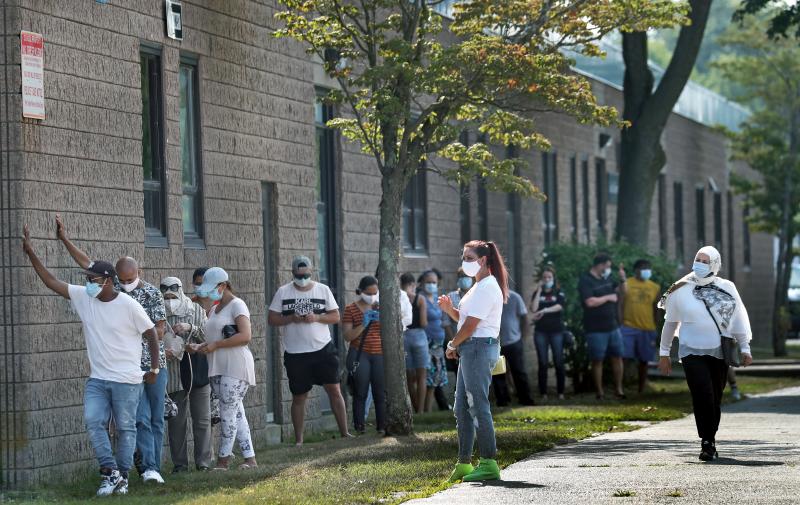 People wait in the shade while in line to get coronavirus tests in Revere, Mass. People wait in the shade while in line to get coronavirus tests in Revere, Mass.
