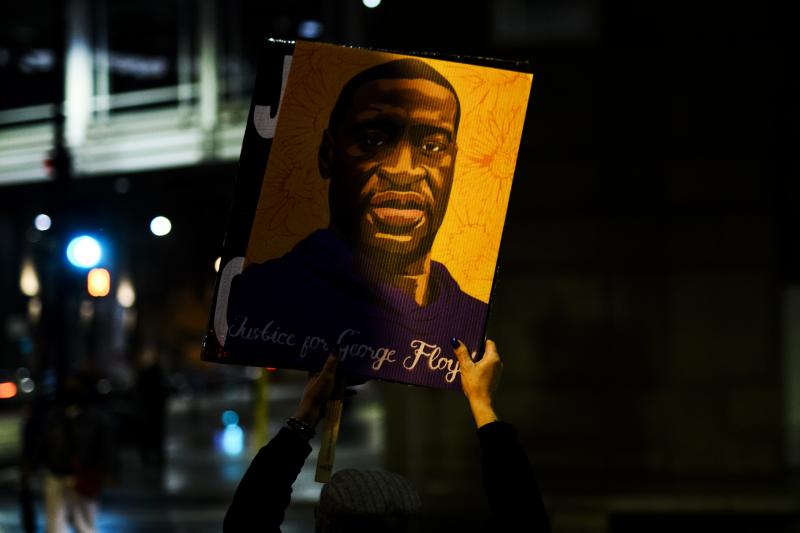 A person holds up a portrait of George Floyd as people gather outside the Hennepin County Government Center on April 9 in Minneapolis A person holds up a portrait of George Floyd as people gather outside the Hennepin County Government Center on April 9 in Minneapolis