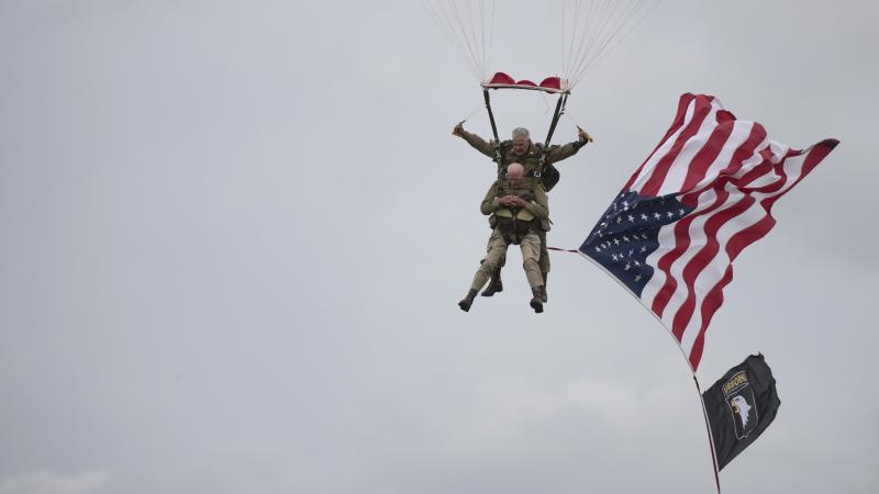 U.S. World War II D-Day veteran Tom Rice, from Coronado, Calif., parachutes in a tandem jump into a field in Carentan, Normandy, France, on Wednesday. Approximately 200 parachutists participated in the event, replicating a jump made by U.S. soldiers on Ju U.S. World War II D-Day veteran Tom Rice, from Coronado, Calif., parachutes in a tandem jump into a field in Carentan, Normandy, France, on Wednesday. Approximately 200 parachutists participated in the event, replicating a jump made by U.S. soldiers on Ju