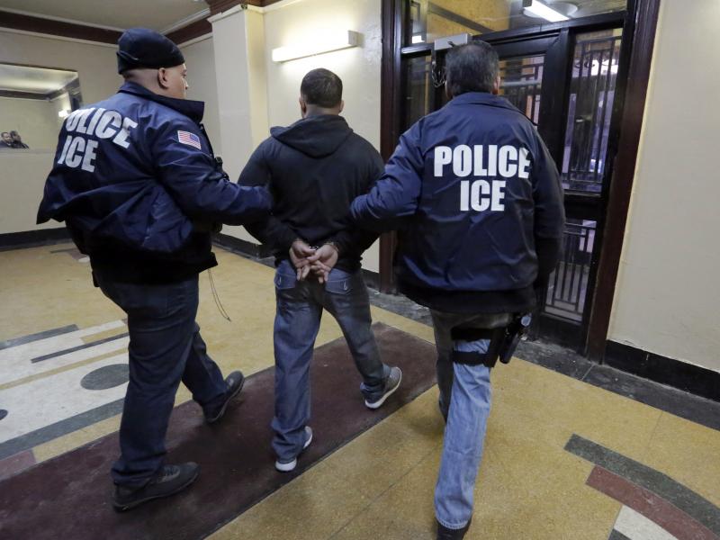 Immigration and Customs Enforcement officers escort a man who was arrested in a New York City apartment building. New York is a city that won't detain noncitizens on behalf of the federal government. Immigration and Customs Enforcement officers escort a man who was arrested in a New York City apartment building. New York is a city that won't detain noncitizens on behalf of the federal government.