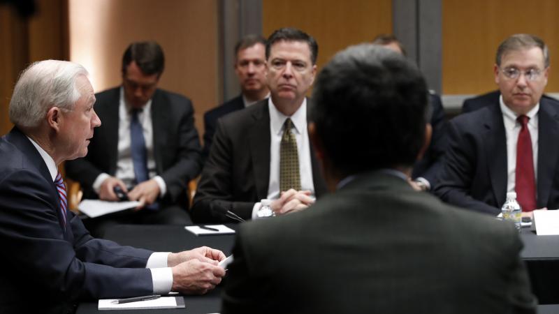 U.S. Attorney General Jeff Sessions (left) speaks with former FBI Director James Comey (center) and other officials at the Department of Justice in April 2017, in Washington. U.S. Attorney General Jeff Sessions (left) speaks with former FBI Director James Comey (center) and other officials at the Department of Justice in April 2017, in Washington.